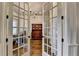 Elegant doorway with french doors leading to a home office with ample natural light at 5340 Cole Creek Ln, Cumming, GA 30040