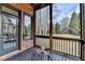 Relaxing screened porch with wooden floors and tranquil backyard views, perfect for enjoying the outdoors at 5340 Cole Creek Ln, Cumming, GA 30040
