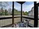 Cozy screened porch with comfortable seating and views of the beautifully landscaped yard at 5340 Cole Creek Ln, Cumming, GA 30040