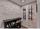 Custom wine cellar with stone accent wall, built-in racks for wine storage at 5340 Cole Creek Ln, Cumming, GA 30040