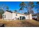View of the home's back exterior with an outdoor seating area and storage shed at 885 Green Valley Dr Nw, Conyers, GA 30012