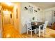 Dining area with a wood table, white chairs, and a decorative clock on the wall at 885 Green Valley Dr Nw, Conyers, GA 30012