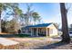 Quaint home featuring a cozy porch with seating, framed by mature trees and lawn at 885 Green Valley Dr Nw, Conyers, GA 30012