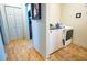 Laundry room featuring modern washer and dryer units with wood-look flooring at 885 Green Valley Dr Nw, Conyers, GA 30012