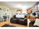 Open-concept living space with a cozy recliner, dining area, and a charming kitchen at 885 Green Valley Dr Nw, Conyers, GA 30012