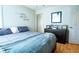 Comfortable bedroom with wood floors, a dresser, and stylish decor, including 'Kiss Me Goodnight' wall art at 885 Green Valley Dr Nw, Conyers, GA 30012