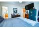 Bedroom with blue bedding, ensuite bathroom access, and a large TV with Sentry safe at 885 Green Valley Dr Nw, Conyers, GA 30012