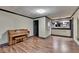 Finished basement space featuring hardwood floors, a piano, and pass-through bar at 2110 Se Murren Se Dr, Smyrna, GA 30080