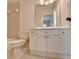 Bathroom featuring a large mirror, ample storage, and a toilet next to a tub with shower at 2110 Se Murren Se Dr, Smyrna, GA 30080
