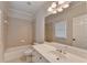 Bathroom featuring a large mirror, ample storage, and a toilet next to a tub with shower at 2110 Se Murren Se Dr, Smyrna, GA 30080