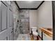 Bathroom featuring a tiled walk-in shower and unique rustic wood vanity at 2110 Se Murren Se Dr, Smyrna, GA 30080