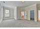 Primary bedroom features neutral carpeting, a large window, and access to ensuite bathroom at 2110 Se Murren Se Dr, Smyrna, GA 30080