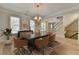 Elegant dining room featuring a wooden table, modern chairs, and natural light, ideal for gatherings and meals at 2110 Se Murren Se Dr, Smyrna, GA 30080