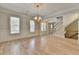 Formal dining room featuring hardwood floors, elegant chandelier, and views of the staircase at 2110 Se Murren Se Dr, Smyrna, GA 30080