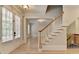 Bright entryway featuring hardwood floors, a staircase, and access to multiple rooms at 2110 Se Murren Se Dr, Smyrna, GA 30080