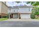 Exterior view of house featuring a deck above a three-car garage at 2110 Se Murren Se Dr, Smyrna, GA 30080