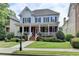 Charming two-story home featuring a welcoming front porch, blue shutters, and well-manicured landscaping at 2110 Se Murren Se Dr, Smyrna, GA 30080