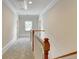 Well-lit hallway featuring neutral walls, plush carpeting, and a classic white railing at 2110 Se Murren Se Dr, Smyrna, GA 30080