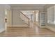 Open-concept living area with hardwood floors, staircase, and built-in shelving at 2110 Se Murren Se Dr, Smyrna, GA 30080