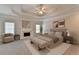Serene main bedroom with a fireplace, tray ceiling, and neutral decor, creating a peaceful retreat at 2110 Se Murren Se Dr, Smyrna, GA 30080