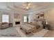 Serene main bedroom with a fireplace, tray ceiling, and neutral decor, creating a peaceful retreat at 2110 Se Murren Se Dr, Smyrna, GA 30080