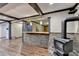 The wet bar area features stone accents, hardwood floors, wood beams and a fireplace at 2110 Se Murren Se Dr, Smyrna, GA 30080