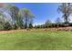 Expansive backyard featuring manicured lawn, mature trees, and lush landscaping at 281 Chilhoe Dr, Canton, GA 30115