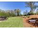 Large manicured backyard with a garden and small lounging tub at 281 Chilhoe Dr, Canton, GA 30115