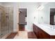 Ensuite bathroom with walk-in shower, double sink vanity, and view of bedroom at 281 Chilhoe Dr, Canton, GA 30115