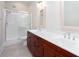 Bathroom with double sink vanity, framed mirrors, and glass door shower at 281 Chilhoe Dr, Canton, GA 30115