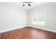Bright bedroom featuring a large window and hardwood floors at 281 Chilhoe Dr, Canton, GA 30115