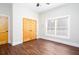 Cozy bedroom with hardwood floors, a window with blinds, and a closet at 281 Chilhoe Dr, Canton, GA 30115