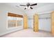 Bedroom with windows, carpet, ceiling fan and closet space at 281 Chilhoe Dr, Canton, GA 30115