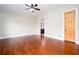 Spacious bedroom with hardwood floors, ceiling fan, ensuite bath and natural wood door at 281 Chilhoe Dr, Canton, GA 30115