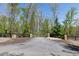 Long paved driveway lined with trees and a black gate entry at 281 Chilhoe Dr, Canton, GA 30115