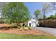 Detached garage with driveway, beautiful landscaping, and charming lawn furniture at 281 Chilhoe Dr, Canton, GA 30115