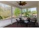 Cozy covered porch with a ceiling fan and outdoor seating overlooking a beautiful yard at 281 Chilhoe Dr, Canton, GA 30115