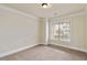 Empty bedroom with neutral carpet and large window with blinds at 3823 Dragon Fly Ln, Loganville, GA 30052