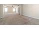 A carpeted bedroom with a tray ceiling, large windows, and plenty of space at 3823 Dragon Fly Ln, Loganville, GA 30052