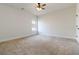 An empty carpeted room with a ceiling fan and a bright window at 3823 Dragon Fly Ln, Loganville, GA 30052