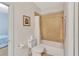 Bathroom with a toilet, shower, and light-colored tiled walls at 498 Townsend St, Grayson, GA 30017