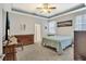 Spacious bedroom boasts neutral walls, carpet, tray ceilings, and a large flat-screen TV at 498 Townsend St, Grayson, GA 30017