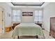 Spacious bedroom featuring a tray ceiling, matching nightstands and bedside lamps at 498 Townsend St, Grayson, GA 30017