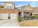 Inviting brick home with a two-car garage and a beautifully landscaped front yard at 498 Townsend St, Grayson, GA 30017