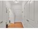Bright hallway with multiple doors, hardwood floors, and neutral paint at 498 Townsend St, Grayson, GA 30017