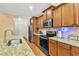 Well-equipped kitchen with wooden cabinets, stainless steel appliances, and granite countertops at 498 Townsend St, Grayson, GA 30017