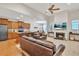 Open-concept living room features a fireplace, TV, and flows seamlessly into the modern kitchen at 498 Townsend St, Grayson, GA 30017