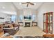 Bright living room with a fireplace, ceiling fan, and a view to the dining room at 498 Townsend St, Grayson, GA 30017