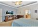 Comfortable main bedroom featuring a fireplace, flatscreen television and views into an en suite bathroom at 498 Townsend St, Grayson, GA 30017