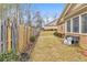 Spacious side yard enclosed by a wooden fence with ample space for outdoor activities at 498 Townsend St, Grayson, GA 30017